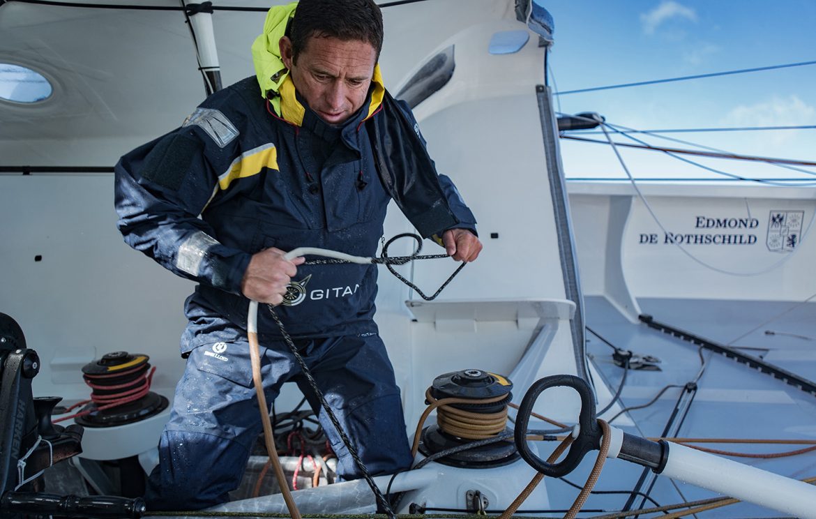 Sebastien Josse hard at work aboard Edmond de Rothschild. Josse recently had to put his race on hold to attempt to repair damage to his boat. Photo: Yann Riou/Gitana SA/Vendée Globe.